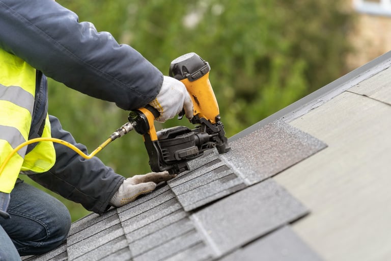 Unrecognizable roofer worker installing tile on roof under construction house