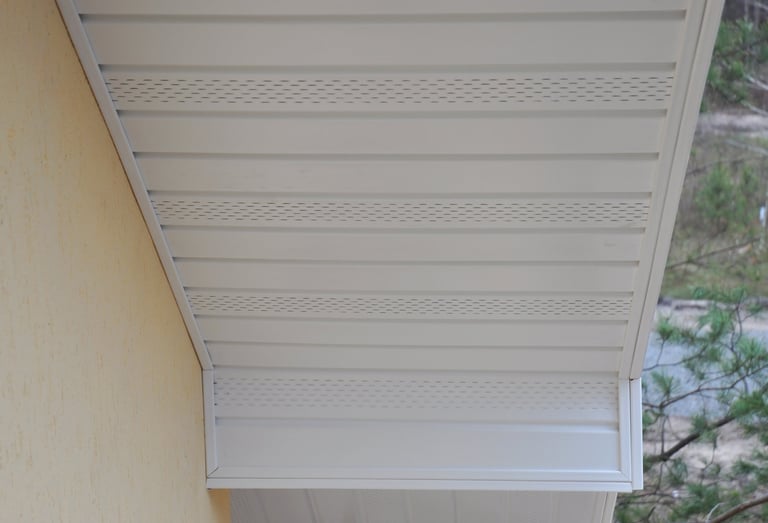 Plastic white uPVC soffit board below the facia of the roof